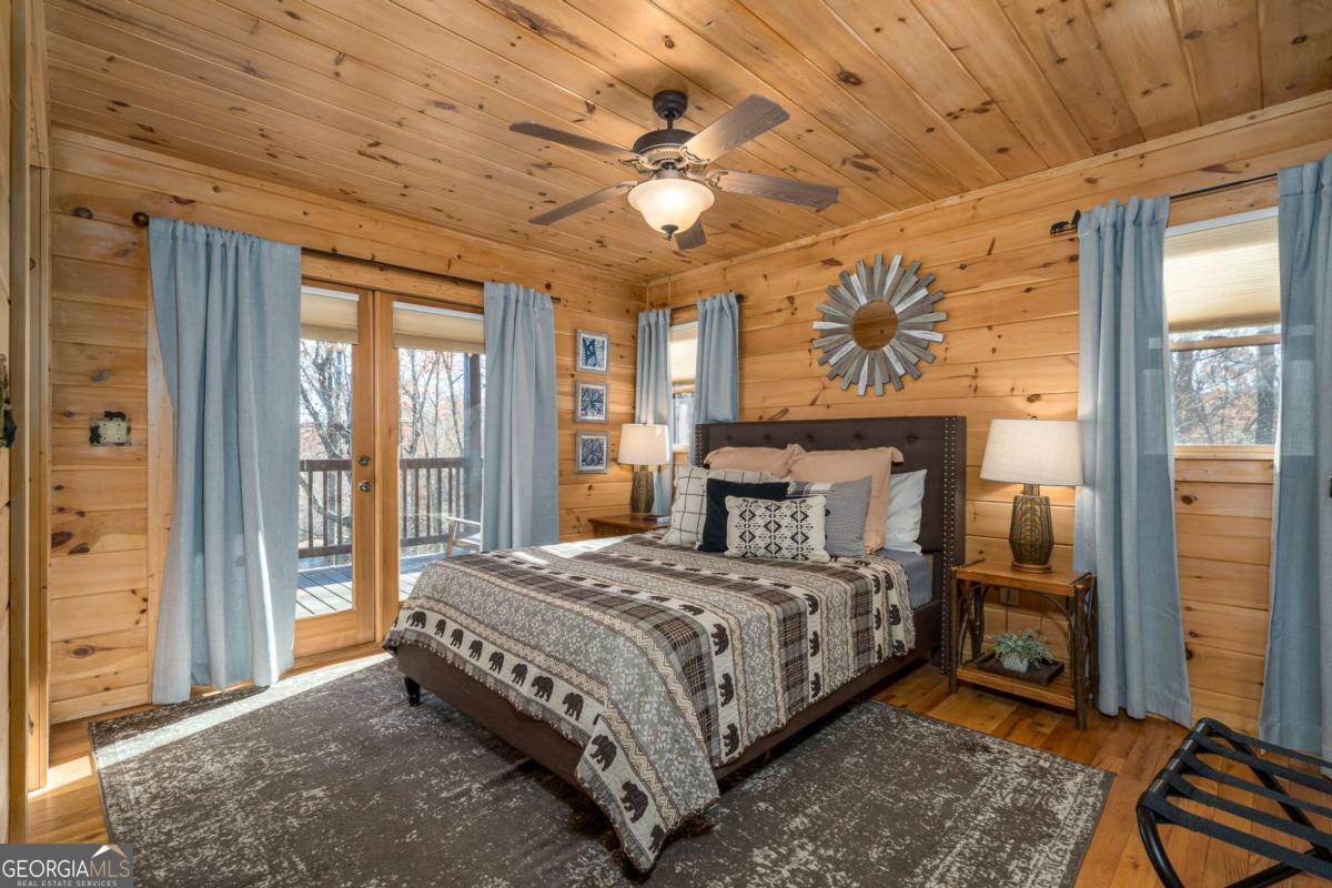 165 Christian Crossing, Unit 15 Morganton, GA 30560 - Photo 31 of 58 a bedroom with a bed and a chandelier