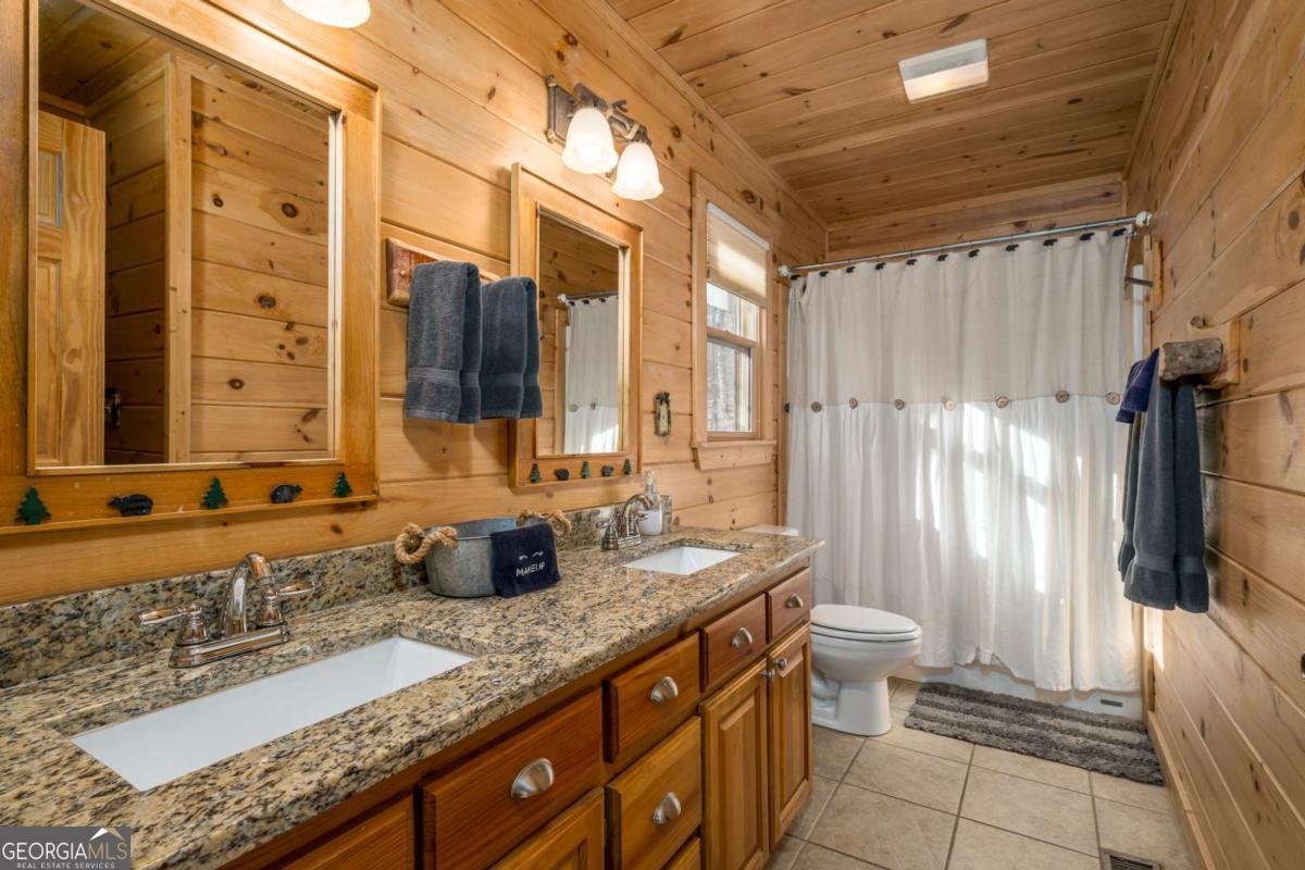 165 Christian Crossing, Unit 15 Morganton, GA 30560 - Photo 32 of 58 a bathroom with a granite countertop sink toilet and shower