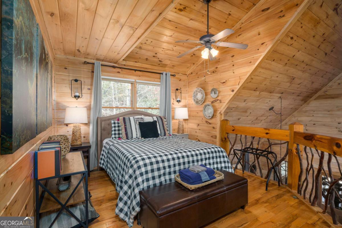 165 Christian Crossing, Unit 15 Morganton, GA 30560 - Photo 34 of 58 a bedroom with a bed and wooden floor