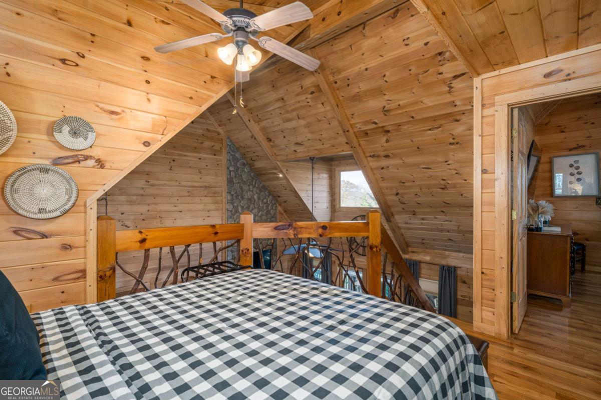 165 Christian Crossing, Unit 15 Morganton, GA 30560 - Photo 35 of 58 a bedroom with a bed and a table