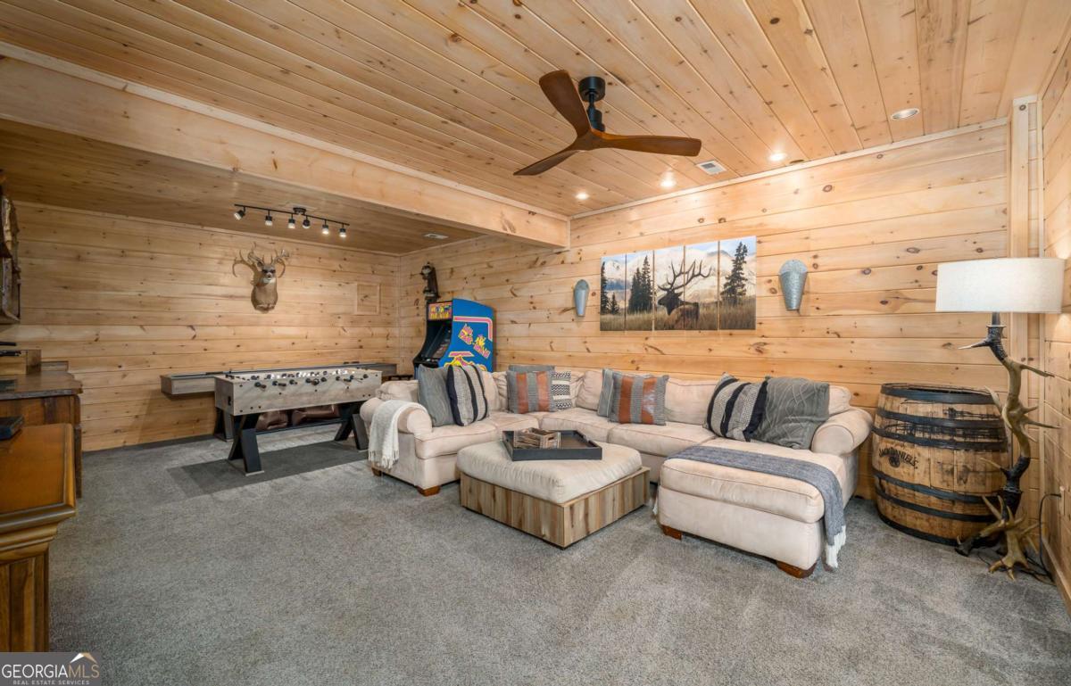 165 Christian Crossing, Unit 15 Morganton, GA 30560 - Photo 42 of 58 a living room with furniture and a chandelier