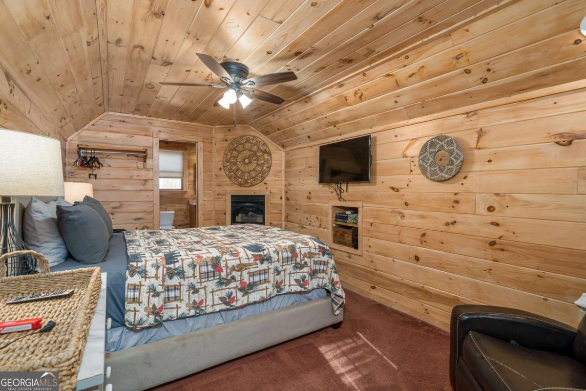 165 Christian Crossing, Unit 15 Morganton, GA 30560 - Photo 57 of 58 a bedroom with a bed dresser and a flat screen tv