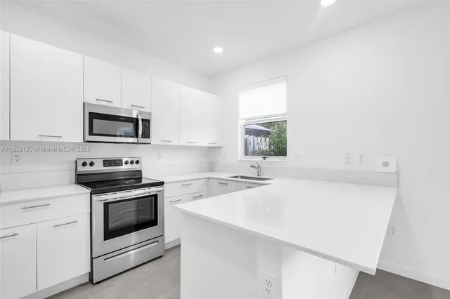 a kitchen with a sink cabinets and window