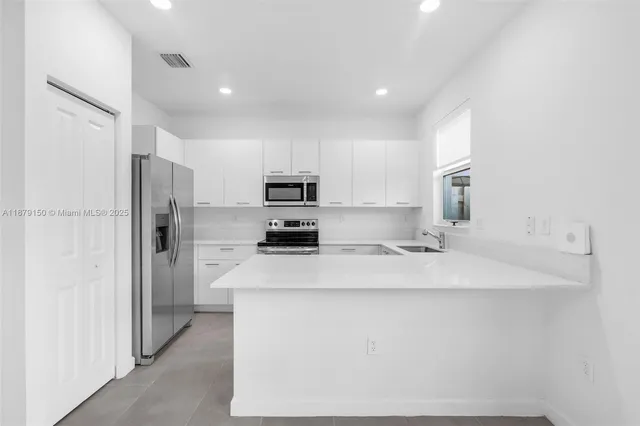 a kitchen with a sink a stove and microwave