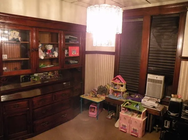 a living room with furniture and a lamp