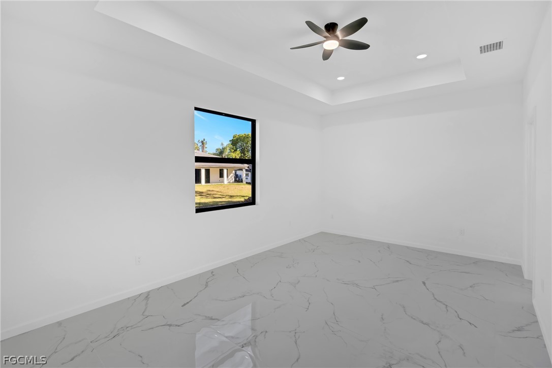 5231 6th Street West Lehigh Acres, FL 33971 - Photo 19 of 26 an empty room with a ceiling fan and window