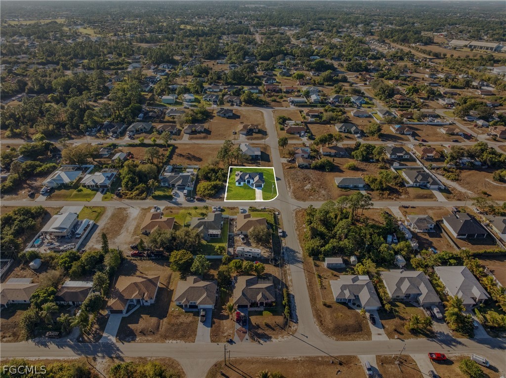 5231 6th Street West Lehigh Acres, FL 33971 - Photo 25 of 26 an aerial view of residential house with parking space