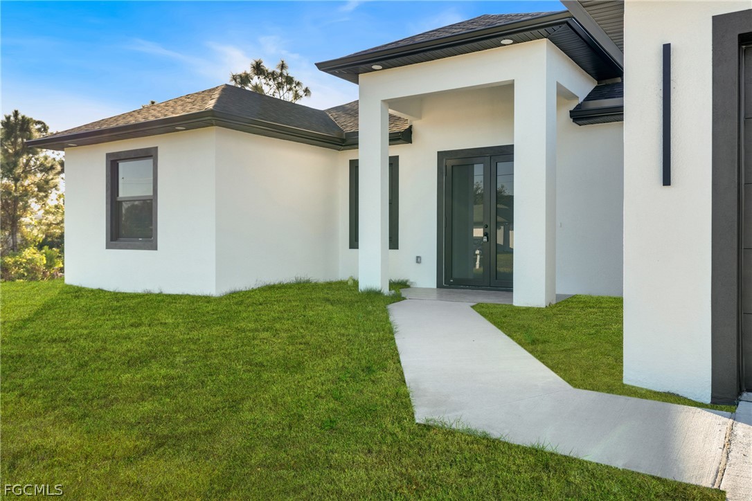 5231 6th Street West Lehigh Acres, FL 33971 - Photo 3 of 26 a view of a house with a yard