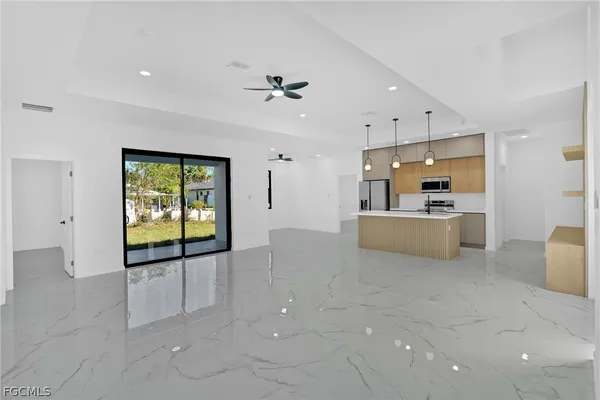 a view of a kitchen with furniture and a ceiling fan