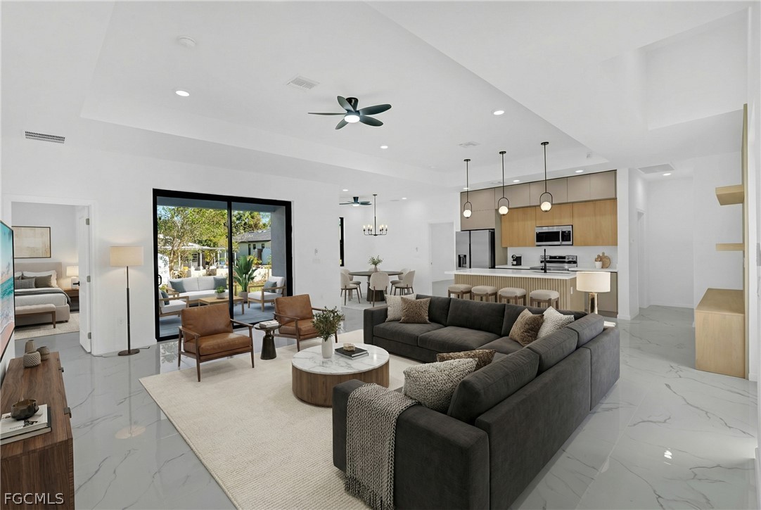 5231 6th Street West Lehigh Acres, FL 33971 - Photo 7 of 26 a living room with furniture kitchen view and a large window