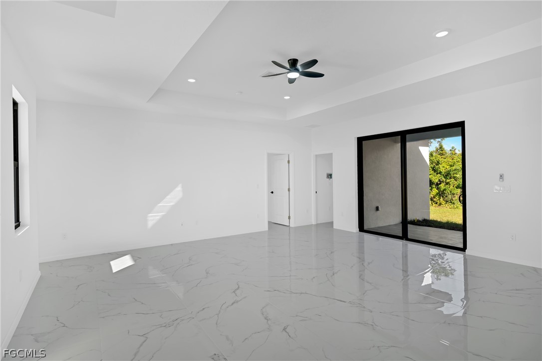 5231 6th Street West Lehigh Acres, FL 33971 - Photo 9 of 26 wooden floor in an empty room with a window