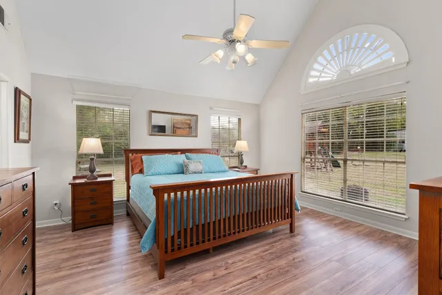 a view of a bedroom with furniture window and wooden floor
