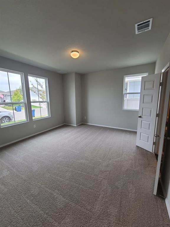 156 Huckleberry Lane Elgin, TX 78621 - Photo 5 of 16 A spacious room with soft carpeting awaits your personal touches.
