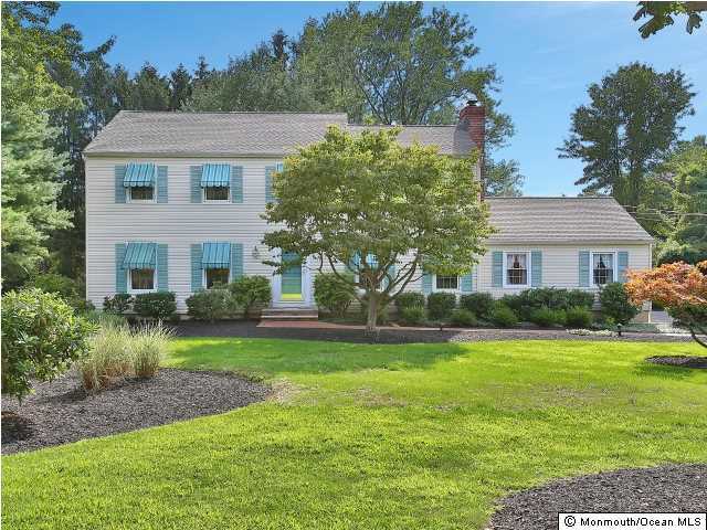 32 Woodhollow Road Colts Neck, NJ 07722 - Photo 1 of 23 a front view of a house with a yard