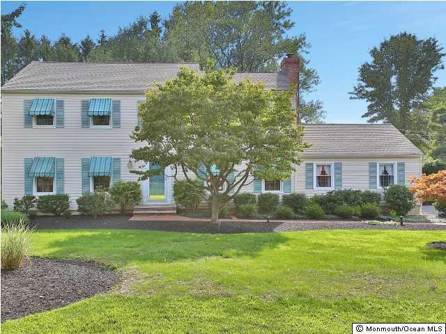 32 Woodhollow Road Colts Neck, NJ 07722 - Photo 2 of 23 a front view of a house with a yard