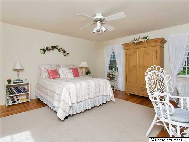 32 Woodhollow Road Colts Neck, NJ 07722 - Photo 11 of 23 a bed room with a bed and a chair