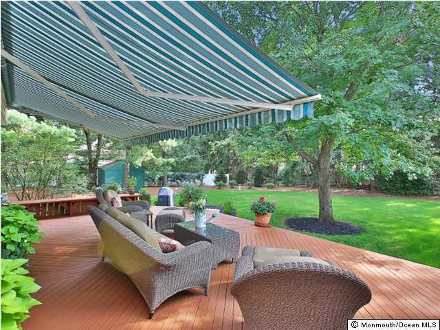 32 Woodhollow Road Colts Neck, NJ 07722 - Photo 16 of 23 a view of a patio with a table chairs and a backyard
