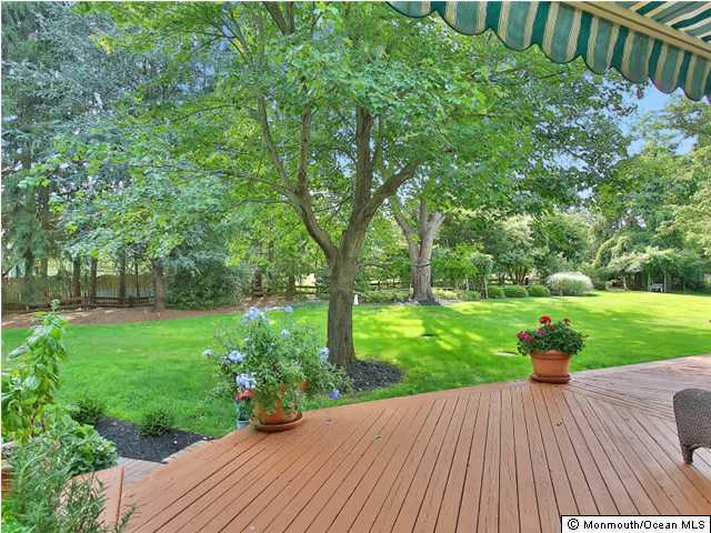 32 Woodhollow Road Colts Neck, NJ 07722 - Photo 20 of 23 a view of a backyard with wooden floor