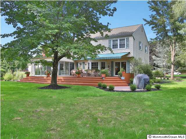 32 Woodhollow Road Colts Neck, NJ 07722 - Photo 22 of 23 a view of a house with a yard porch and sitting area