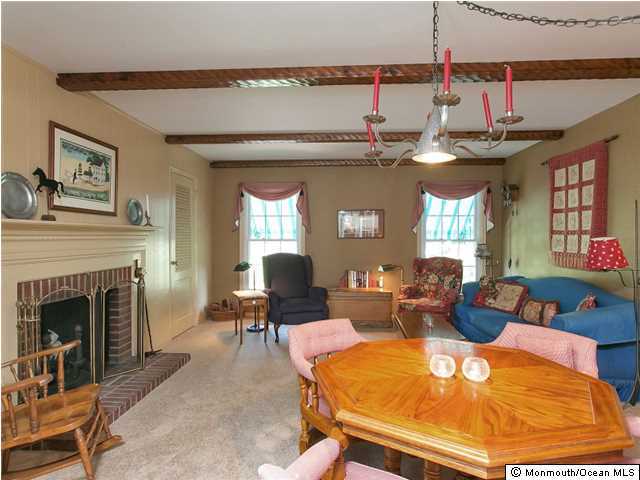 32 Woodhollow Road Colts Neck, NJ 07722 - Photo 8 of 23 a living room with furniture a fireplace and a flat screen tv