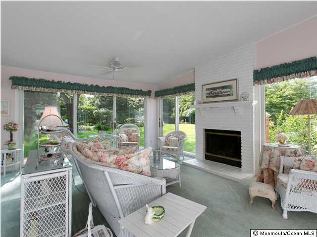 32 Woodhollow Road Colts Neck, NJ 07722 - Photo 9 of 23 a living room with furniture a fireplace and a floor to ceiling window
