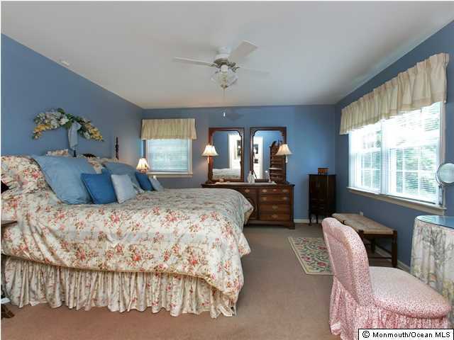 32 Woodhollow Road Colts Neck, NJ 07722 - Photo 10 of 23 a spacious bedroom with two beds and a large window