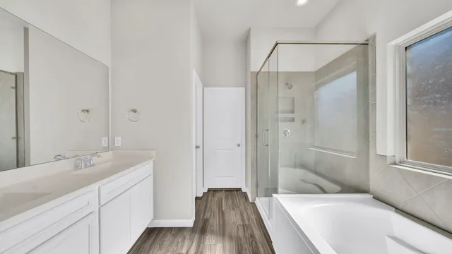 a spacious bathroom with a tub shower and sink