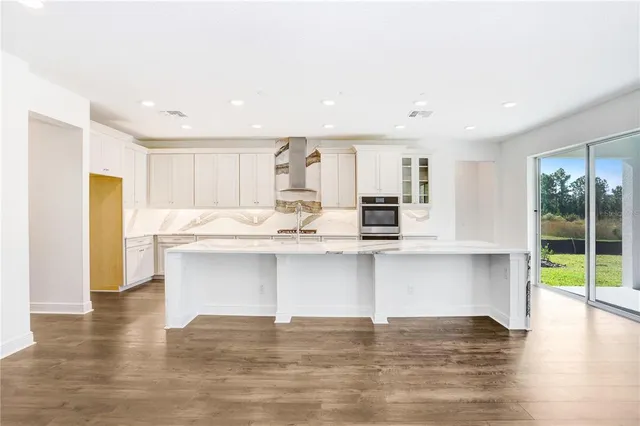 a kitchen with a stove sink and a refrigerator