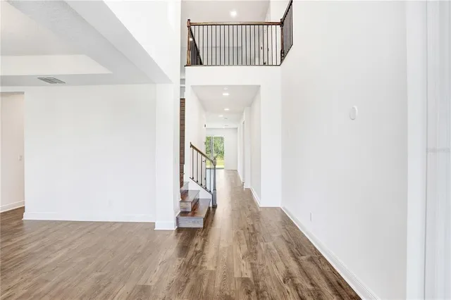 a view of a hallway with wooden floor