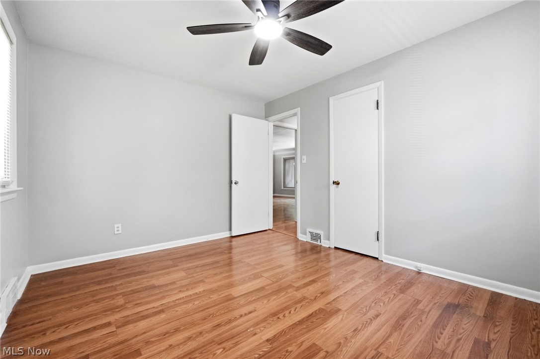 2537 Edgewood Road Beachwood, OH 44122 - Photo 28 of 39 Room featuring wood-finish flooring, light grey walls, white trim, and a ceiling fan with integrated lighting