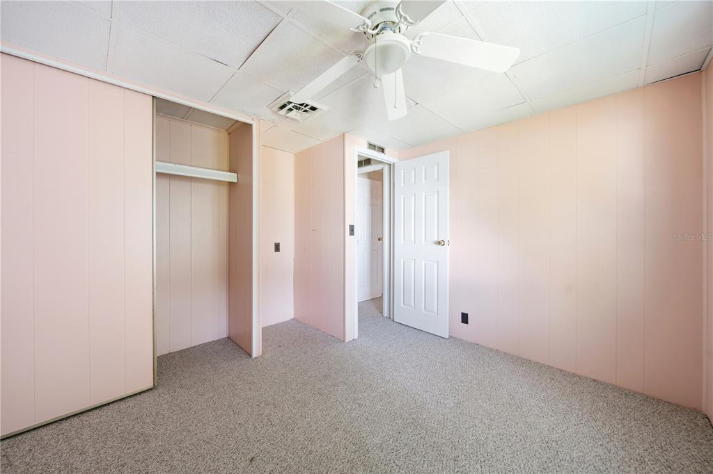 1000 Walker Street, Unit 160 Daytona Beach, FL 32117 - Photo 11 of 34 an empty room with a ceiling fan and a window