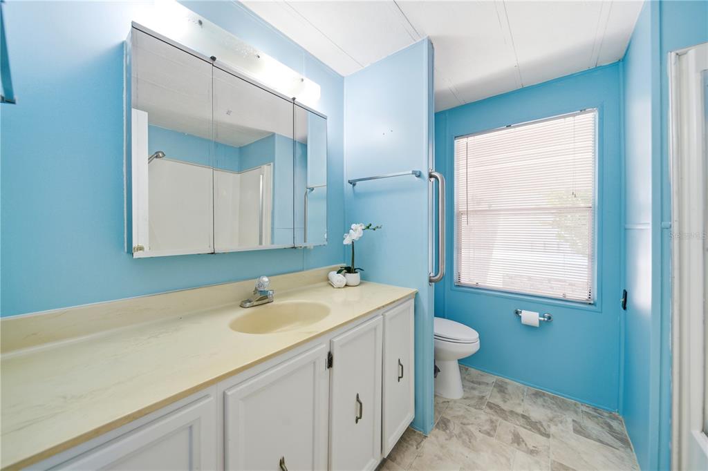 1000 Walker Street, Unit 160 Daytona Beach, FL 32117 - Photo 12 of 34 a bathroom with a sink a toilet and a mirror