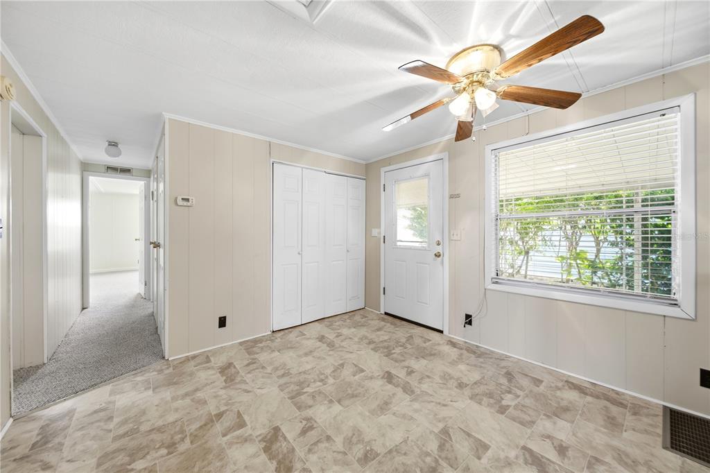 1000 Walker Street, Unit 160 Daytona Beach, FL 32117 - Photo 13 of 34 a view of an empty room with window and chandelier fan