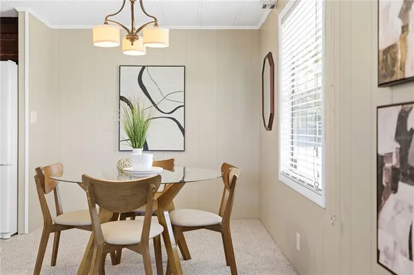 a view of a dining room with furniture and a chandelier