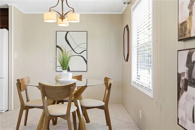 a view of a dining room with furniture and a chandelier