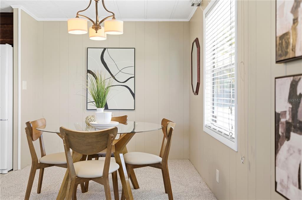 1000 Walker Street, Unit 160 Daytona Beach, FL 32117 - Photo 14 of 34 a view of a dining room with furniture and a chandelier