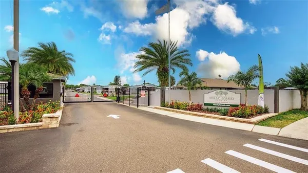 a view of a street with a building and couple of trees in front of it