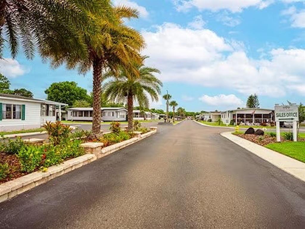 1000 Walker Street, Unit 160 Daytona Beach, FL 32117 - Photo 25 of 34 a view of a street with a building and couple of trees in front of it
