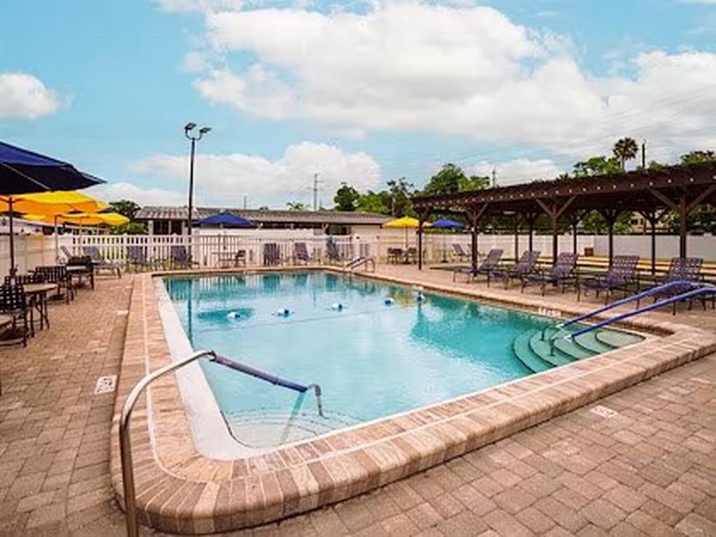 1000 Walker Street, Unit 160 Daytona Beach, FL 32117 - Photo 29 of 34 a view of a swimming pool with a lounge chairs