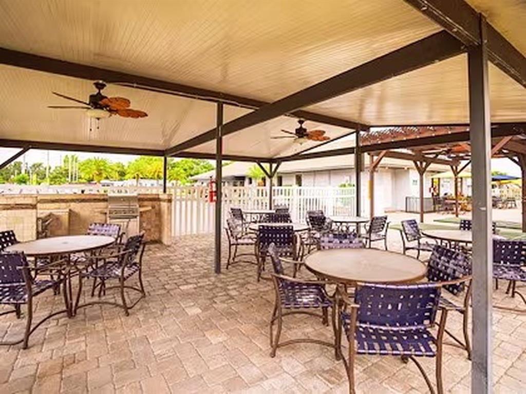 1000 Walker Street, Unit 160 Daytona Beach, FL 32117 - Photo 30 of 34 a patio with a table a table and chairs