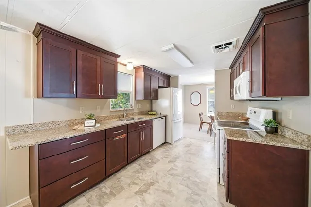 a kitchen with a sink stove and wooden cabinets