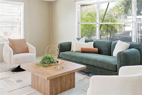 a living room with furniture and a large window