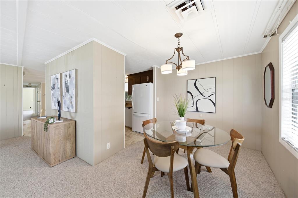 1000 Walker Street, Unit 160 Daytona Beach, FL 32117 - Photo 8 of 34 a view of a dining room with furniture and chandelier