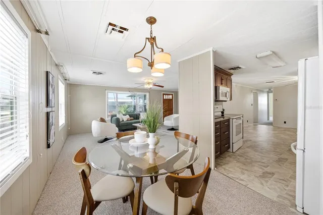 a view of a dining room with furniture and a chandelier