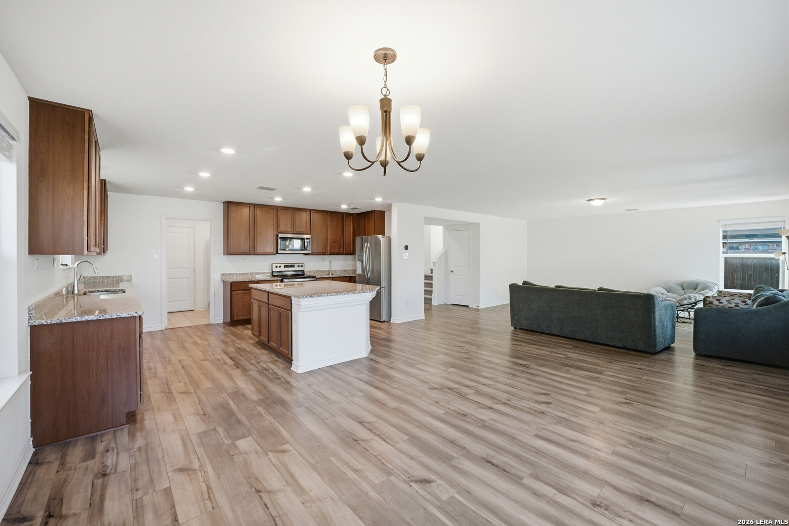 11331 Edelweiss San Antonio, TX 78245 - Photo 6 of 19 a large kitchen with stainless steel appliances granite countertop a stove and a wooden floors