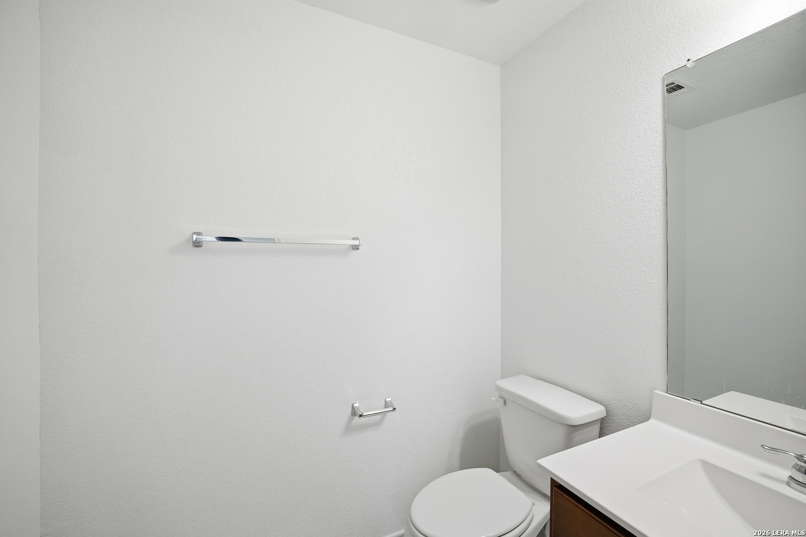 11331 Edelweiss San Antonio, TX 78245 - Photo 8 of 19 a white toilet sitting next to a white sink and vanity