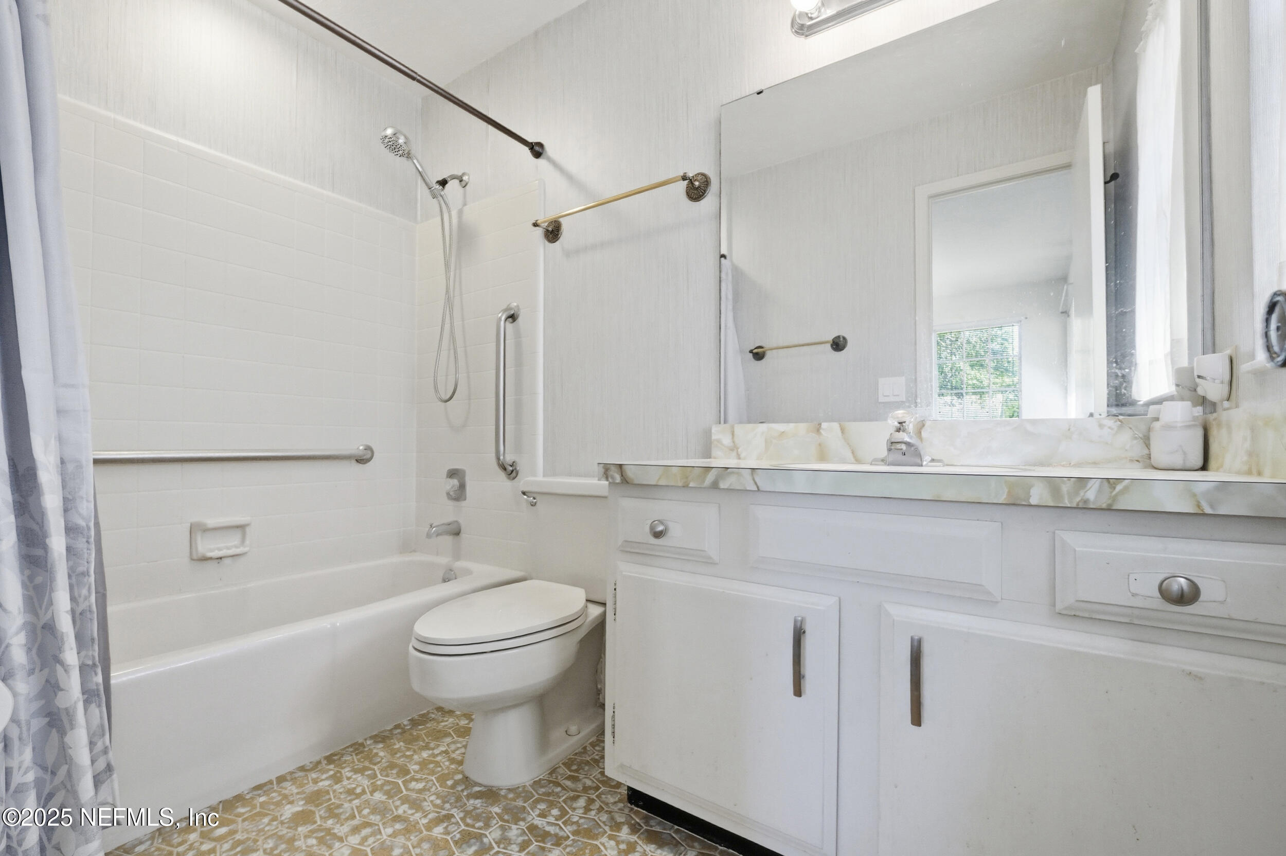 4073 Big Hollow Lane Jacksonville, FL 32277 - Photo 18 of 31 a bathroom with a sink a toilet and a bathtub