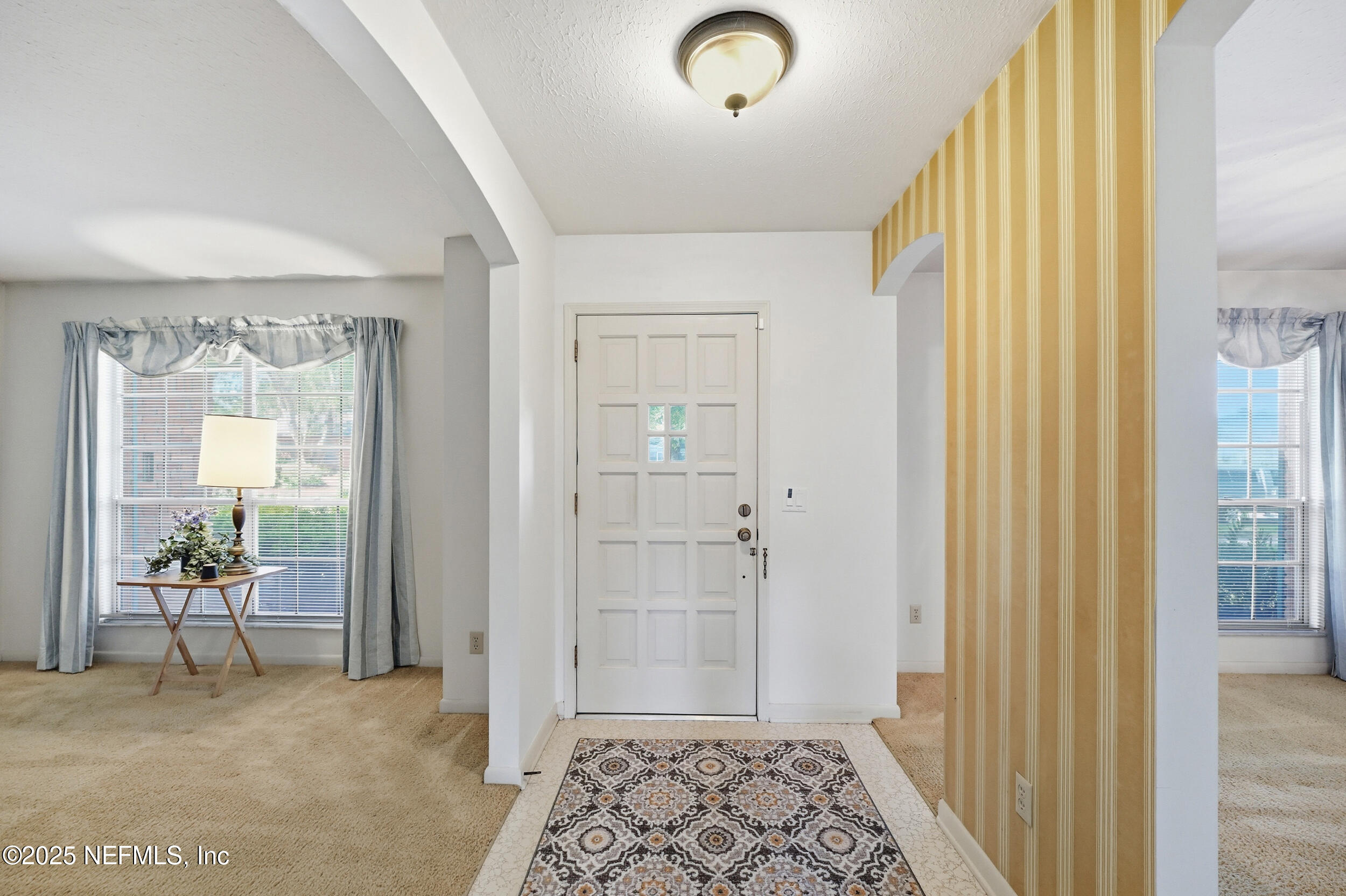 4073 Big Hollow Lane Jacksonville, FL 32277 - Photo 3 of 31 a view of a hallway with wooden floor and a bedroom