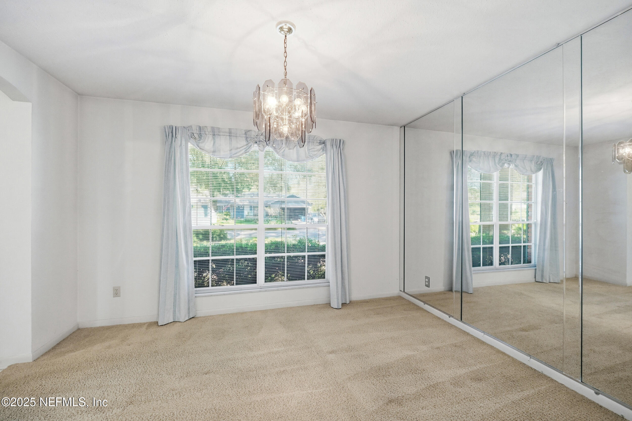 4073 Big Hollow Lane Jacksonville, FL 32277 - Photo 5 of 31 a view of a big room with windows and chandelier