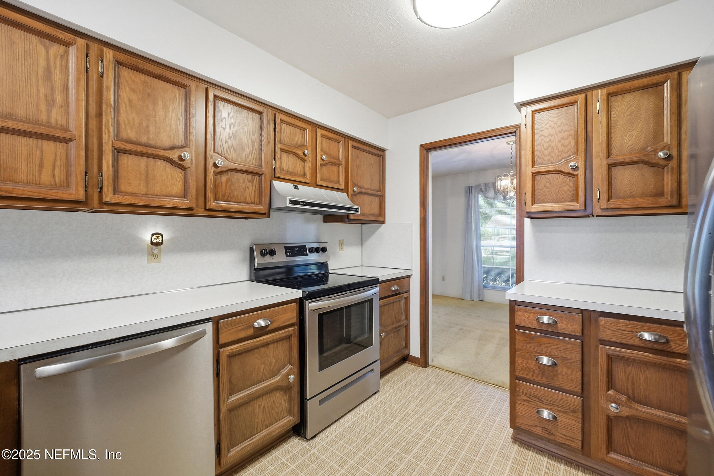 4073 Big Hollow Lane Jacksonville, FL 32277 - Photo 7 of 31 a kitchen with stainless steel appliances granite countertop a stove and a sink